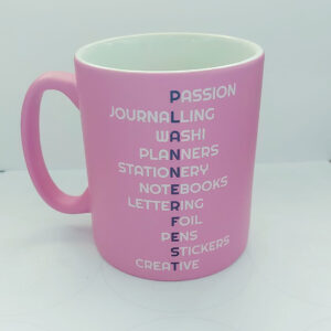 Pink Satin Finish Mug with Plannerfest in purple down the middle and different words associated with planning coming off the main image