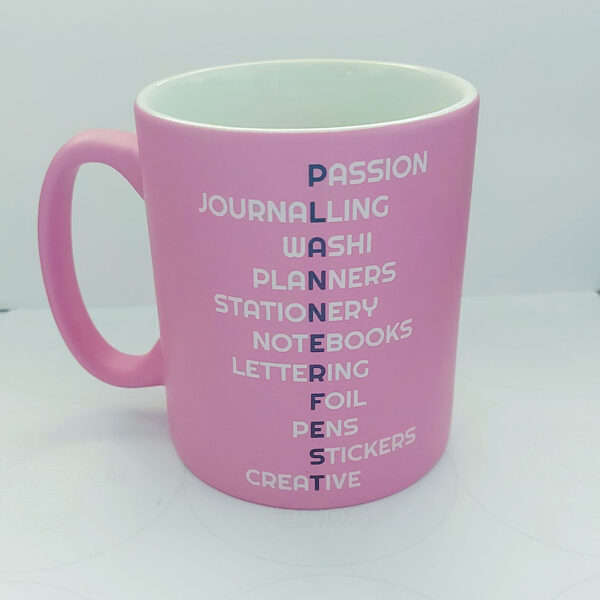 Pink Satin Finish Mug with Plannerfest in purple down the middle and different words associated with planning coming off the main image